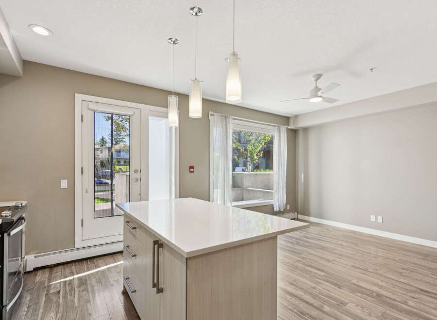 Discover modern living in this bright and airy open-concept space, featuring a sleek kitchen island perfect for entertaining.