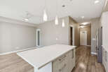 Experience modern living in this spacious open-concept condo, featuring a sleek kitchen island perfect for entertaining.