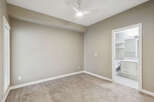 Step into this inviting bedroom featuring plush carpeting and a modern ceiling fan for year-round comfort.