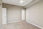 This spacious bedroom features a neutral color palette, creating a serene and inviting atmosphere.