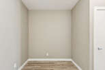 This image showcases an empty room with neutral-toned walls and a light wood-look floor, creating a blank canvas for potential buyers.