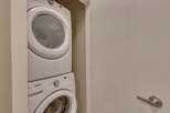 Discover the convenience of in-suite laundry with this stacked washer and dryer unit, perfect for maximizing space in your home.