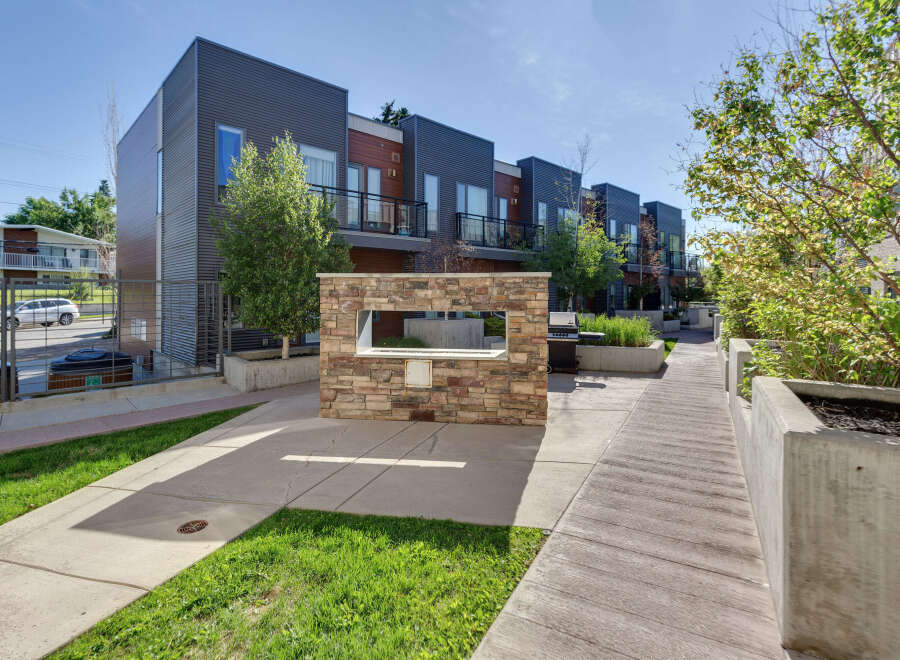 Discover modern living in this row of contemporary townhouses featuring sleek metal siding and warm wood accents.