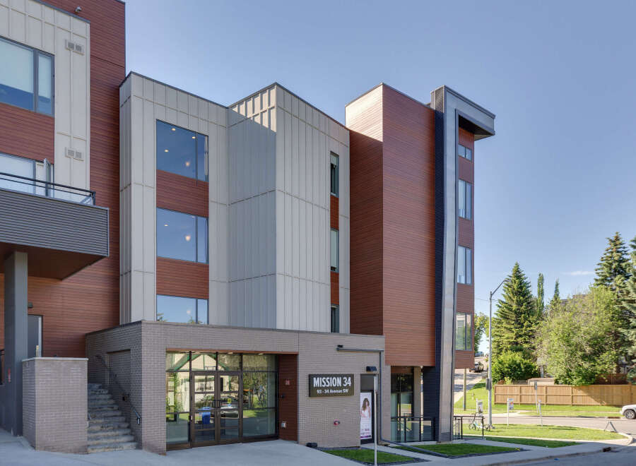 Discover modern living at Mission 34, featuring a striking architectural design with warm wood accents and sleek metal paneling.