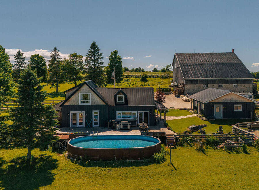 Escape to this stunning rural property featuring a modern dark-clad home with a spacious deck and above-ground pool, perfect for summer relaxation.