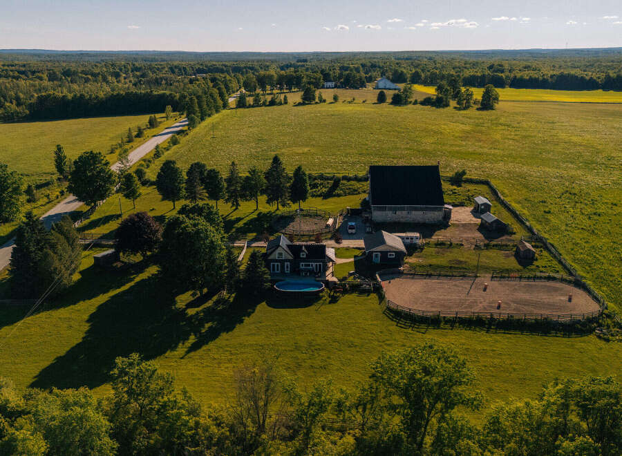 Discover this stunning rural estate featuring a spacious home with a private pool, a large barn, and a dedicated riding arena.