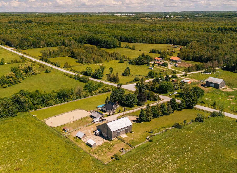 Discover this expansive rural property featuring a charming farmhouse, a large barn, and a dedicated riding arena, perfect for equestrian enthusiasts.