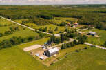 Discover this expansive rural property featuring a charming farmhouse, a large barn, and a dedicated riding arena, perfect for equestrian enthusiasts.