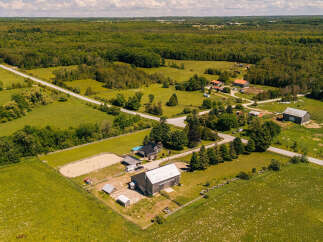 Discover this expansive rural property featuring a charming farmhouse, a large barn, and a dedicated riding arena, perfect for equestrian enthusiasts.