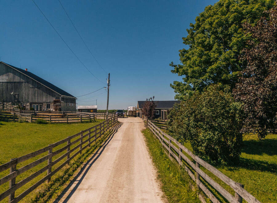Discover this charming rural property featuring a classic wooden barn with 'TRIVUE RIDGE' signage, perfect for agricultural use or conversion.