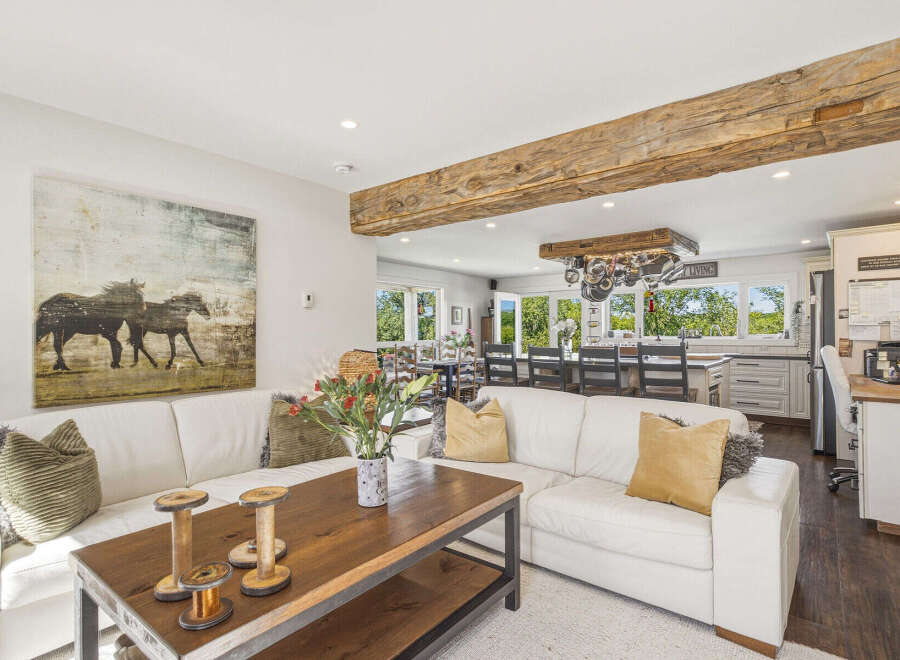 Experience rustic charm and modern comfort in this spacious living area, featuring a large sectional sofa perfect for gatherings.