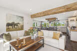 Experience rustic charm and modern comfort in this spacious living area, featuring a large sectional sofa perfect for gatherings.