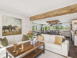 Experience rustic charm and modern comfort in this spacious living area, featuring a large sectional sofa perfect for gatherings.