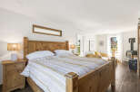 Experience rustic charm and modern comfort in this inviting bedroom.