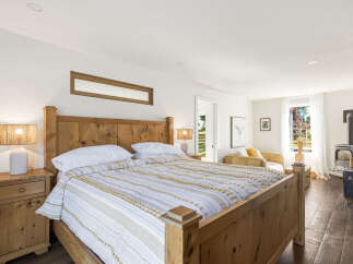 Experience rustic charm and modern comfort in this inviting bedroom.