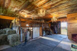 Step into this charming rustic barn, featuring multiple horse stalls and ample hay storage, perfect for equestrian enthusiasts.