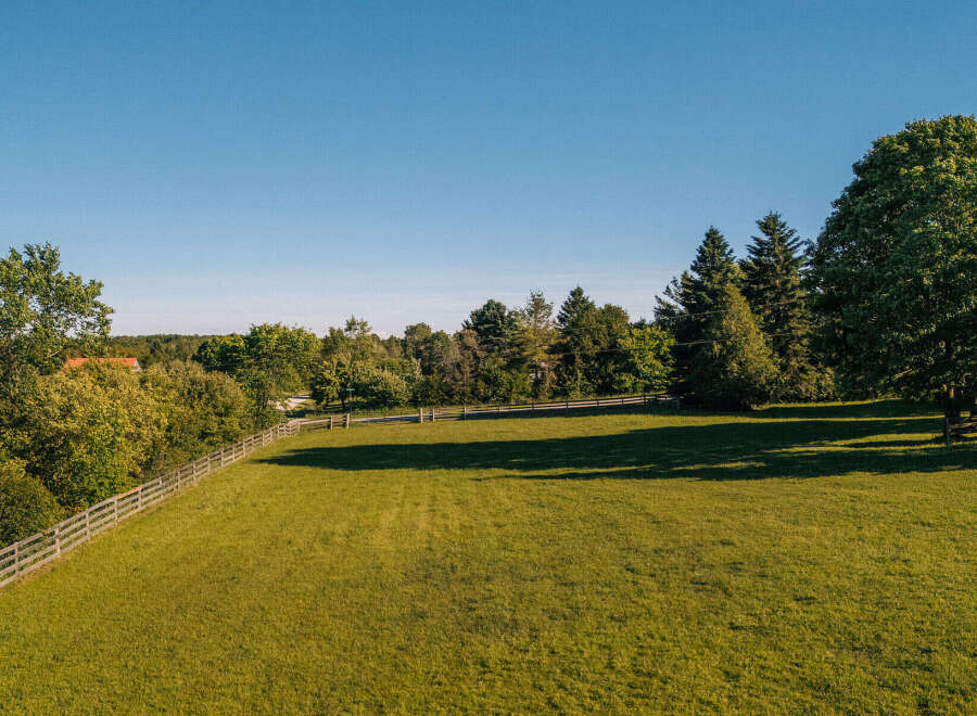 Discover this stunning property featuring a vast, sun-drenched green lawn perfect for outdoor activities and relaxation.
