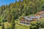Experience luxury mountain living in this stunning chalet, nestled amidst a lush forest with breathtaking views.