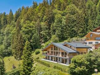 Experience luxury mountain living in this stunning chalet, nestled amidst a lush forest with breathtaking views.