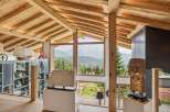 Experience breathtaking mountain views from this stunning architectural masterpiece, featuring exposed wooden beams and expansive windows that flood the space with natural light.