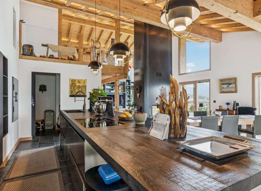 Experience luxury living in this stunning open-concept kitchen and dining area, featuring a spacious wooden island perfect for entertaining.