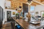 Experience luxury living in this stunning open-concept kitchen and dining area, featuring a spacious wooden island perfect for entertaining.