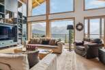 Experience breathtaking mountain views from this luxurious living room, featuring a grand fireplace and expansive windows that bring the outdoors in.