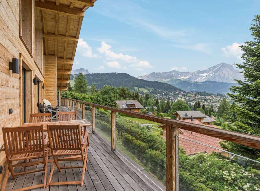 Experience breathtaking mountain views from this stunning wooden balcony, perfect for enjoying your morning coffee or evening wine.