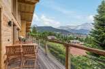 Experience breathtaking mountain views from this stunning wooden balcony, perfect for enjoying your morning coffee or evening wine.