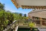 Enjoy breathtaking panoramic views from this stunning balcony, overlooking a serene lake and majestic mountains.