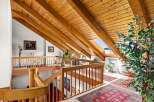Ascend to a lofted paradise with stunning vaulted wood-beam ceilings and a skylight offering breathtaking views.