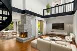Experience modern living in this stunning multi-level loft featuring a dramatic stone fireplace as the centerpiece of the spacious living area.