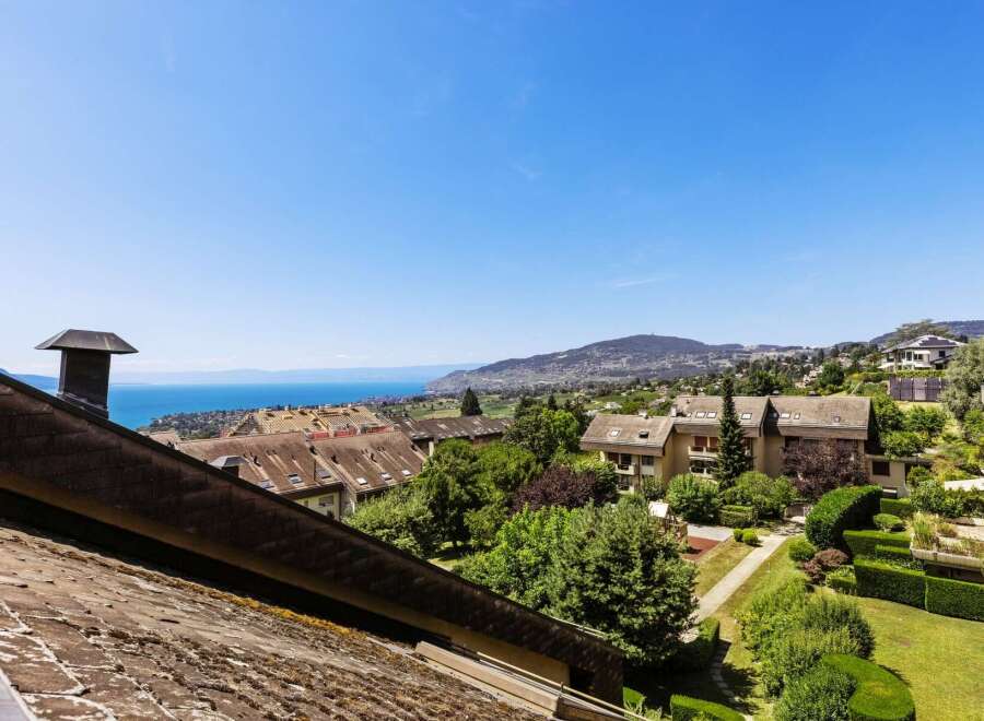 Enjoy breathtaking lake and mountain views from this stunning property, offering a serene escape with lush greenery and well-maintained landscaping.