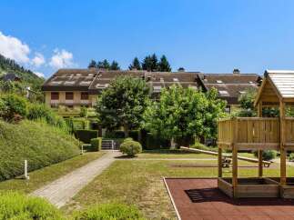 Discover this charming property featuring a well-maintained playground with a sandbox and seesaw, perfect for family fun.
