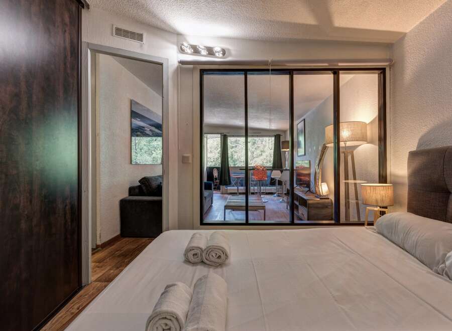 Experience comfort and style in this beautifully appointed bedroom, featuring a plush king-sized bed and elegant bedside lamps.