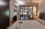 Experience comfort and style in this beautifully appointed bedroom, featuring a plush king-sized bed and elegant bedside lamps.