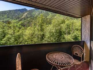Enjoy breathtaking mountain views from this charming balcony, perfect for your morning coffee or evening relaxation.