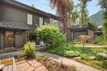 Discover this charming property featuring a dark wood exterior and a welcoming entrance with a covered porch.