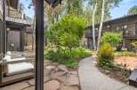 Experience the tranquility of this mountain retreat, featuring a charming courtyard with flagstone pathways and lush greenery.