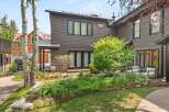 Experience modern living in this stunning home featuring dark wood siding and a sleek metal roof.