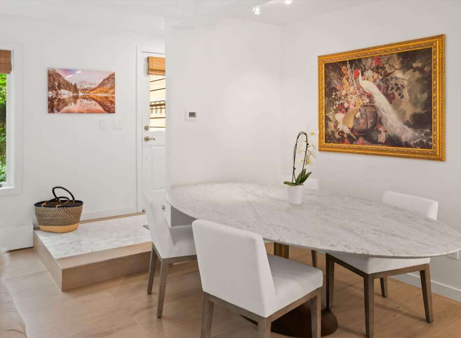 This elegant dining area features a stunning marble-top oval table, perfect for intimate gatherings or family meals.