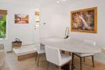 This elegant dining area features a stunning marble-top oval table, perfect for intimate gatherings or family meals.