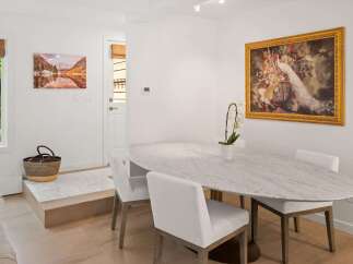 This elegant dining area features a stunning marble-top oval table, perfect for intimate gatherings or family meals.
