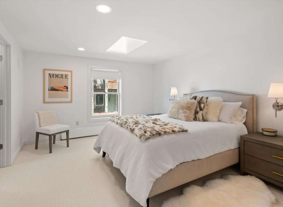 Experience luxury and comfort in this beautifully appointed bedroom, featuring a plush king-sized bed adorned with soft, textured pillows and a cozy throw.