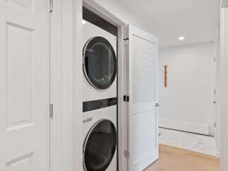 Discover modern convenience with this stacked LG washer and dryer set, perfect for maximizing space in your home.