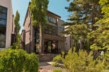 Experience modern luxury in this stunning multi-story residence, featuring a striking contemporary facade with a blend of stone and stucco finishes.