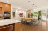 Experience modern living in this spacious dining area, featuring a sleek oval dining table surrounded by comfortable upholstered chairs.