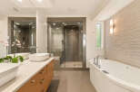 Experience luxury in this modern bathroom featuring a freestanding soaking tub and a spacious glass-enclosed shower with sleek tilework.