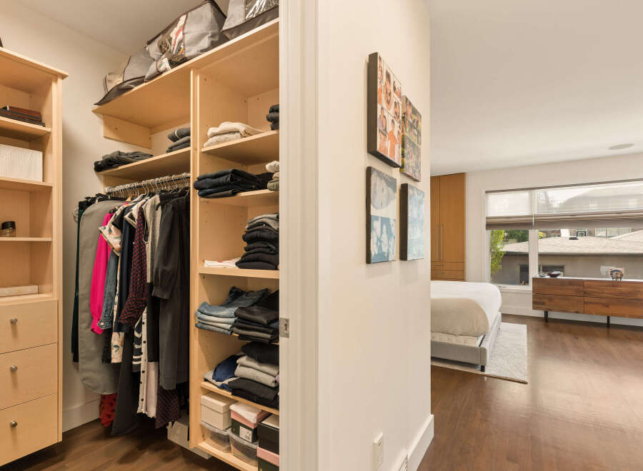 Step into a spacious walk-in closet featuring ample shelving and hanging space, perfect for organizing your wardrobe.