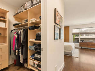 Step into a spacious walk-in closet featuring ample shelving and hanging space, perfect for organizing your wardrobe.